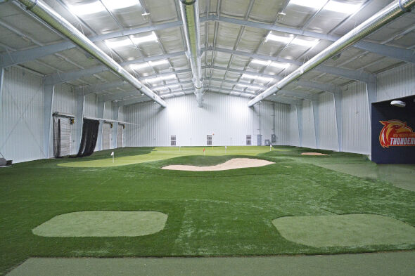 Indoor putting facility with tee boxes